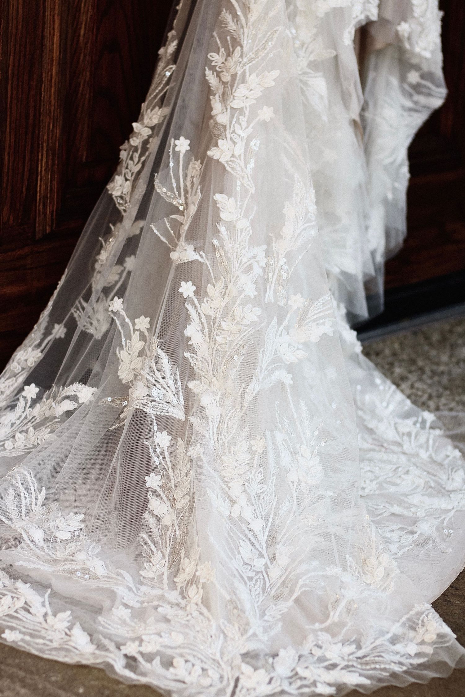 Intricate floral lace detail on wedding dress train.