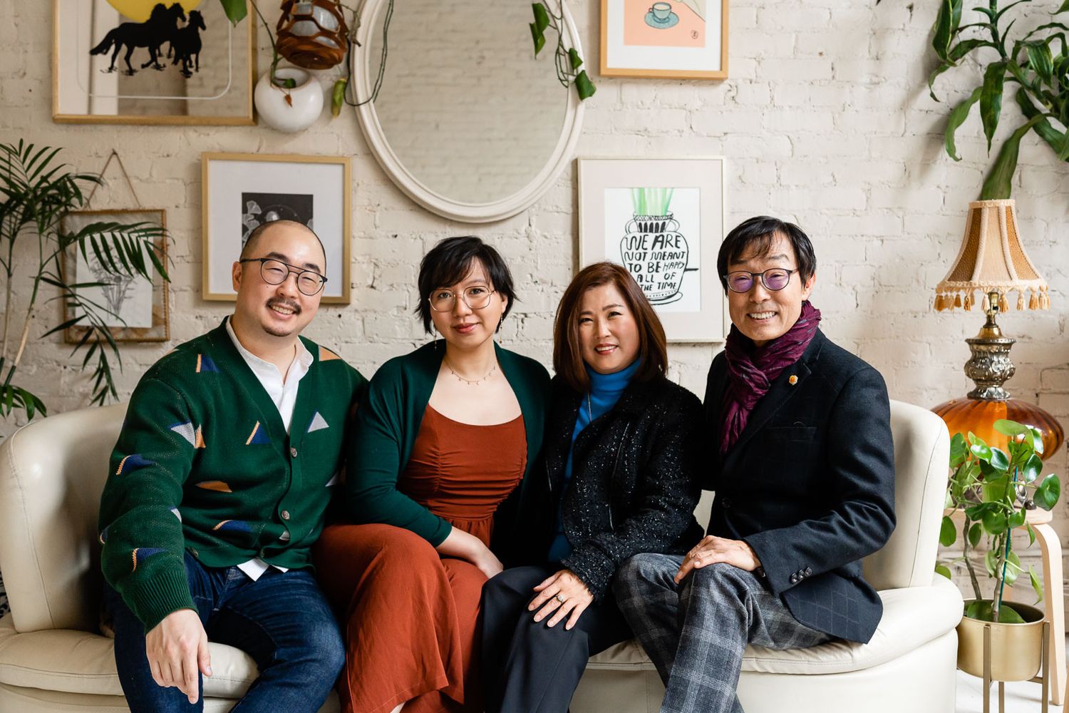 Seattle family photographer captures posed portrait against a funky art gallery wall