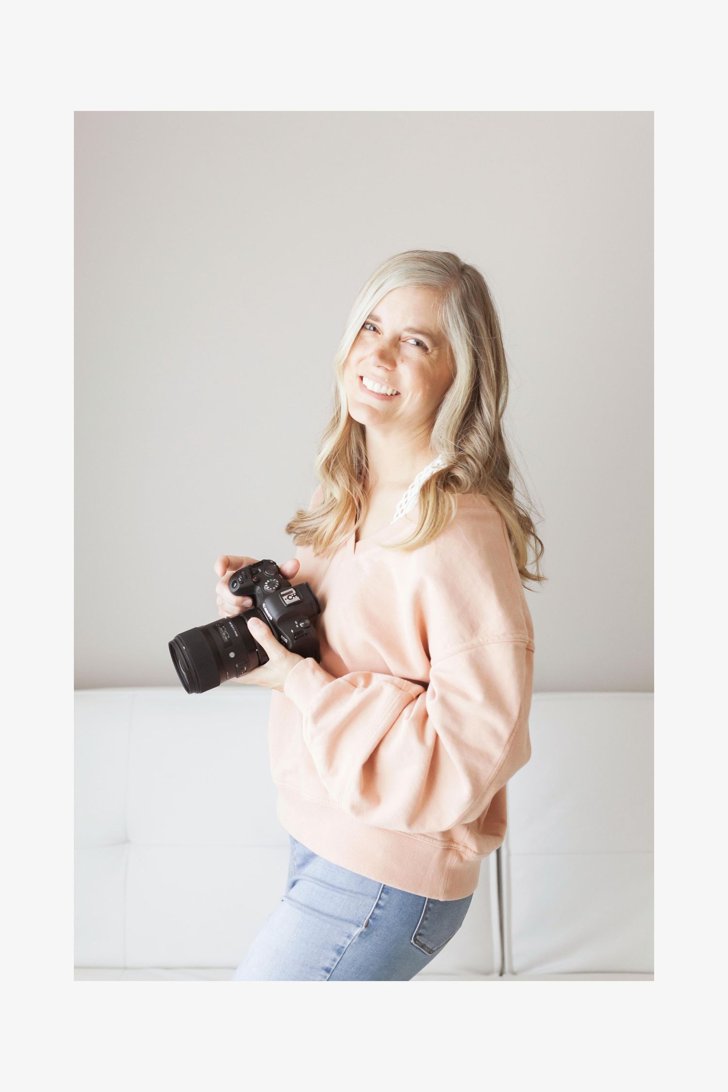 Wichita KS Photographer Lesley Moody holding camera and smiling