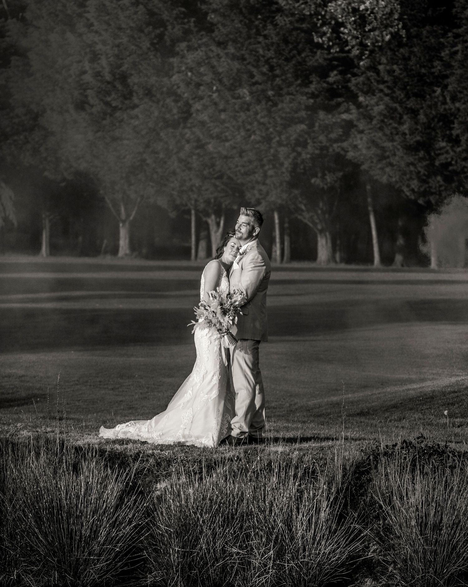 A romantic black and white wedding photo sequence showing a couple embracing in an outdoor garden setting.