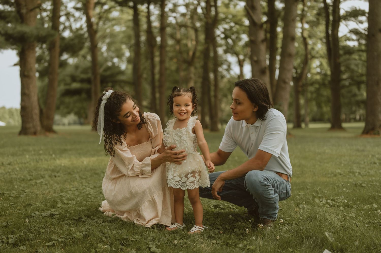 A joyful family moment captured in a sunlit forest setting.