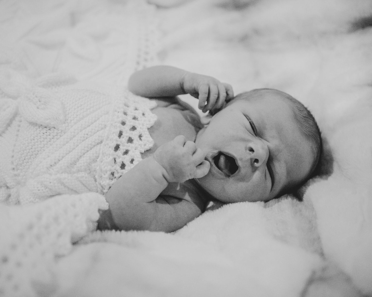 New born at home photo shoot with Cornwall new born photographer baby yawning