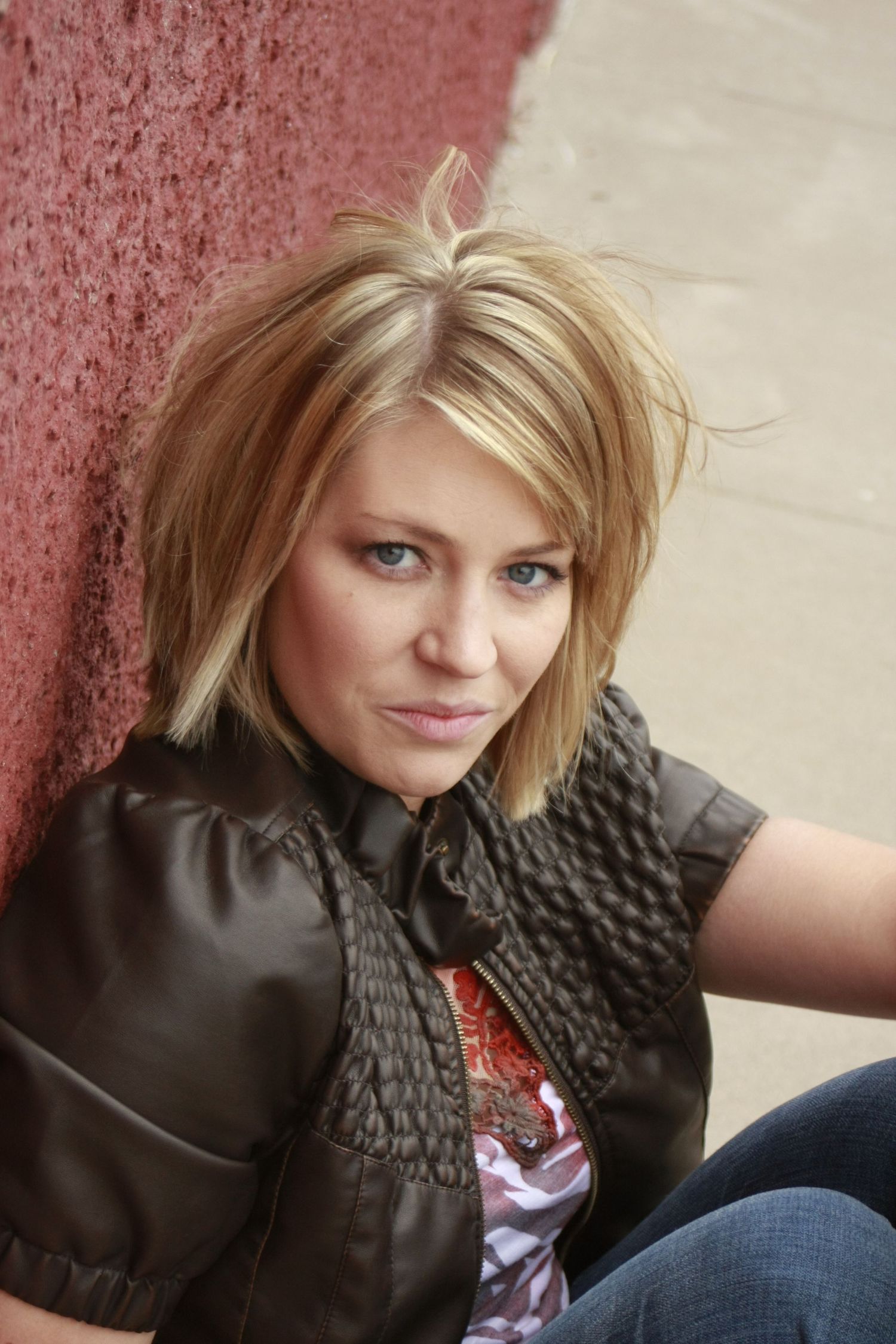 A series of close-up portrait shots against a pink textured wall showing a black knit scarf.