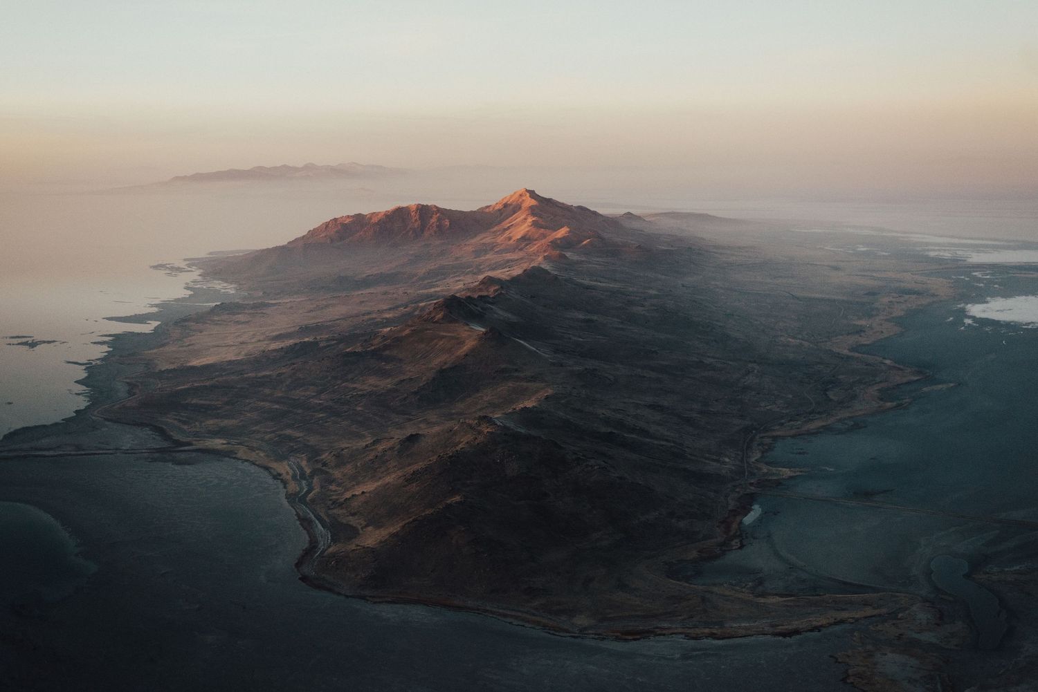 Panoramic coastal mountain landscape view during golden hour.
