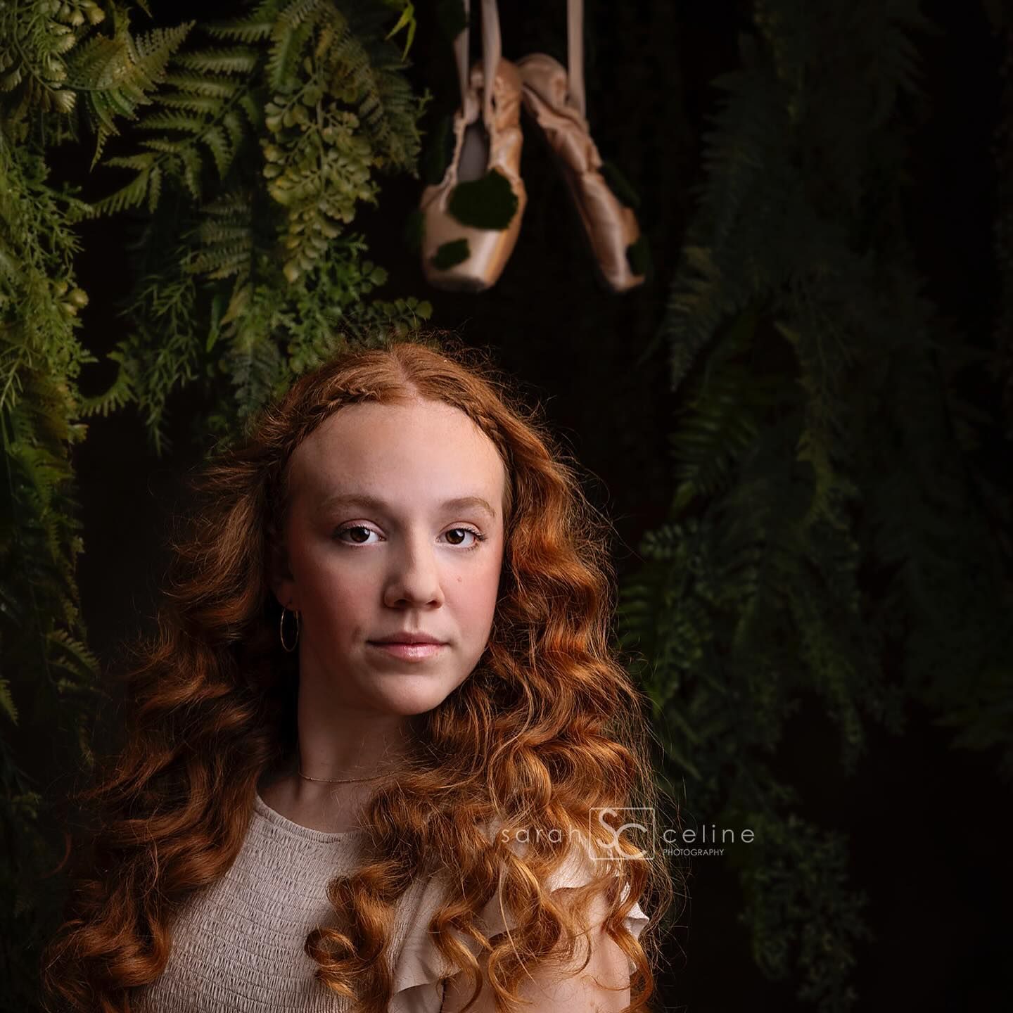 Ethereal portrait with flowing red hair surrounded by greenery. Taylor Swift inspired.