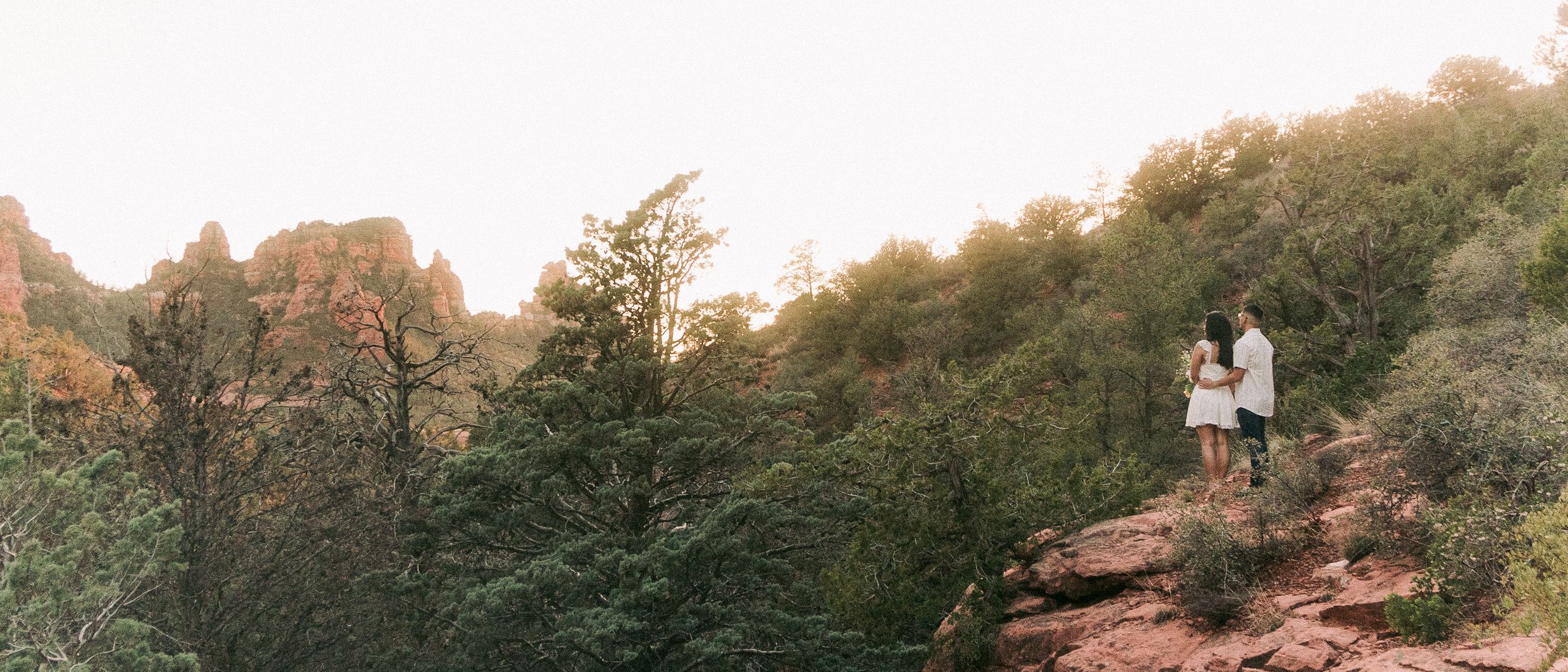 Intimate Sedona engagement session captures the beauty of the couple staring into the mountains and sunset, by Sergio Ga