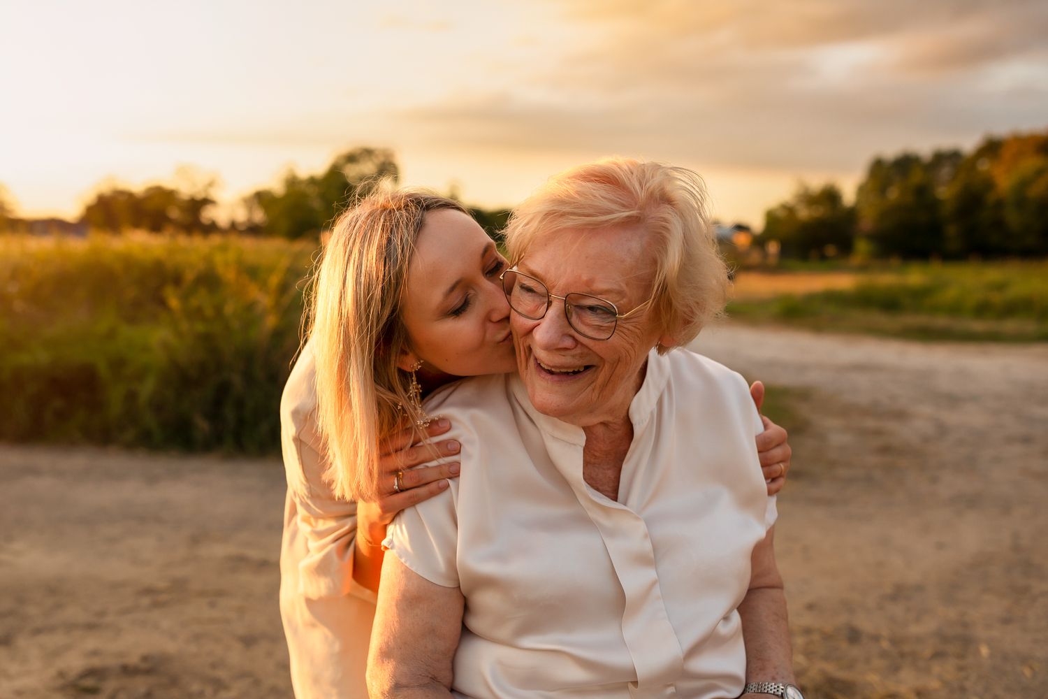 A tender moment of affection shared during golden hour in a rural setting.