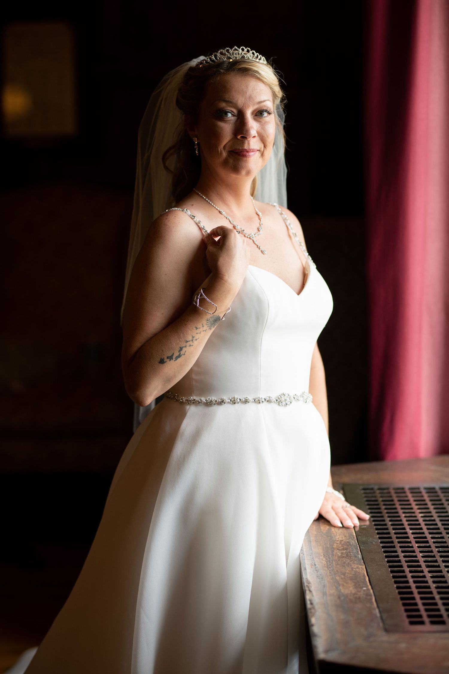 Bride posing in the light of a window