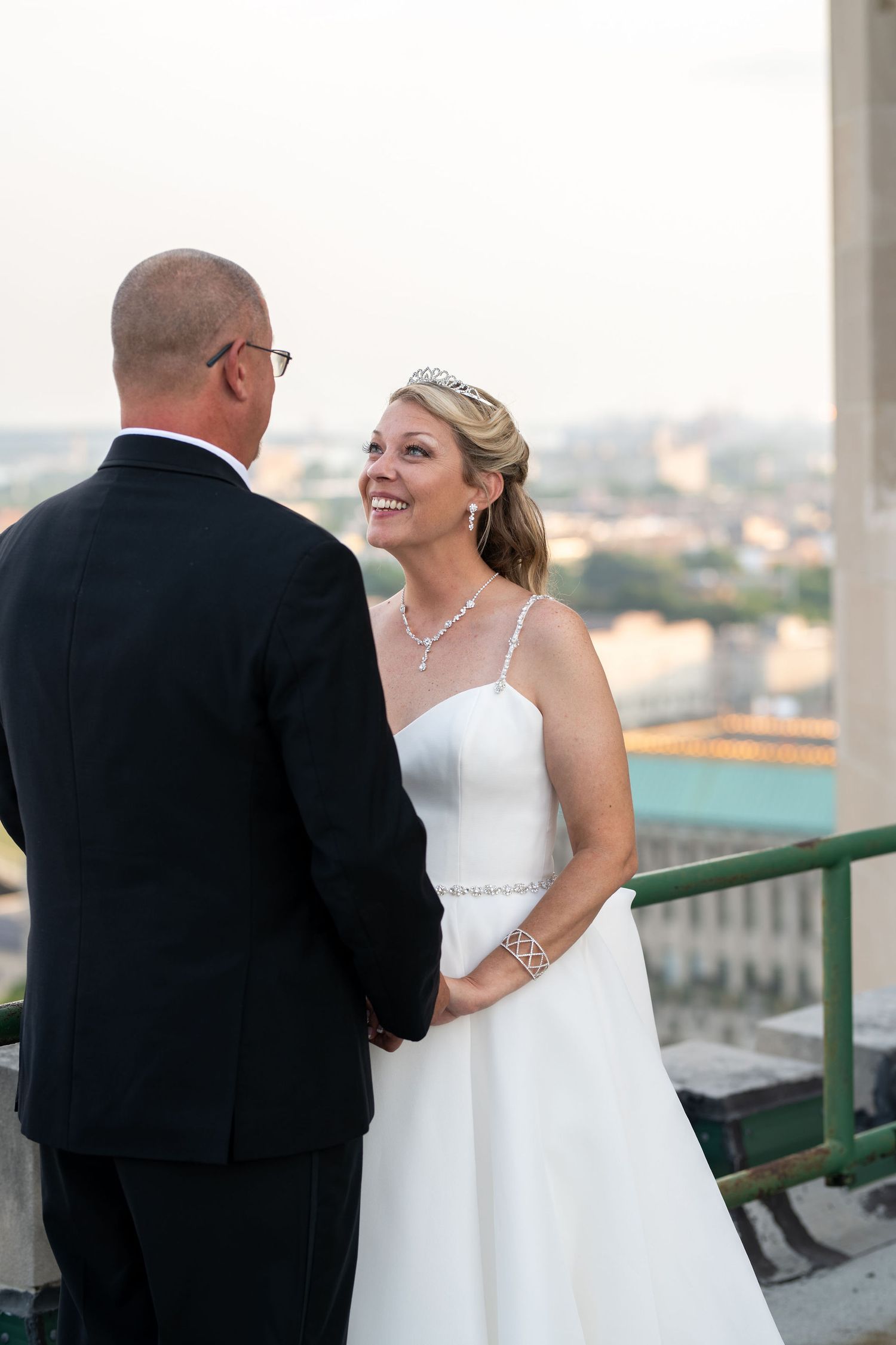 Bride smiling at groom on a rooftop in Detroit