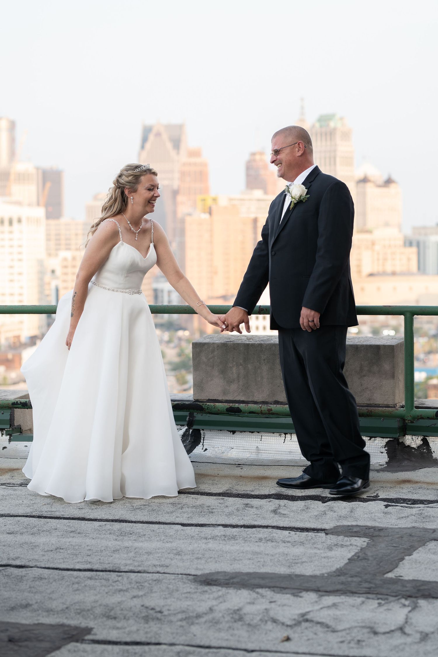 Bride and Groom laughing on a Rooftop in Detroit