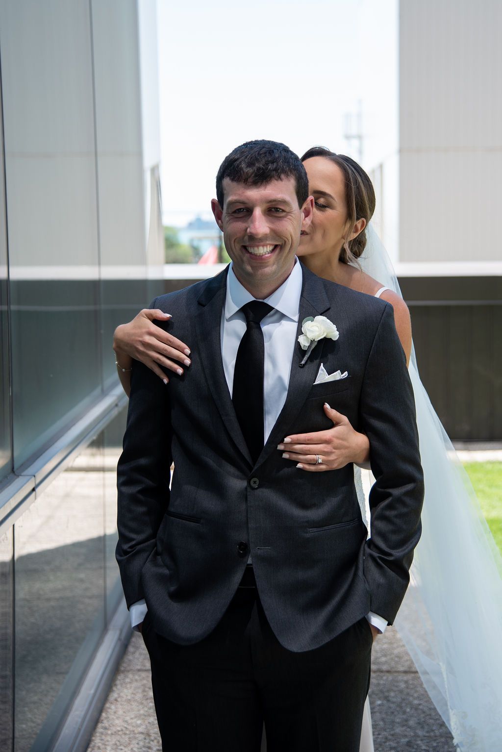 Bride Hugging Groom From Behind on Rooftop