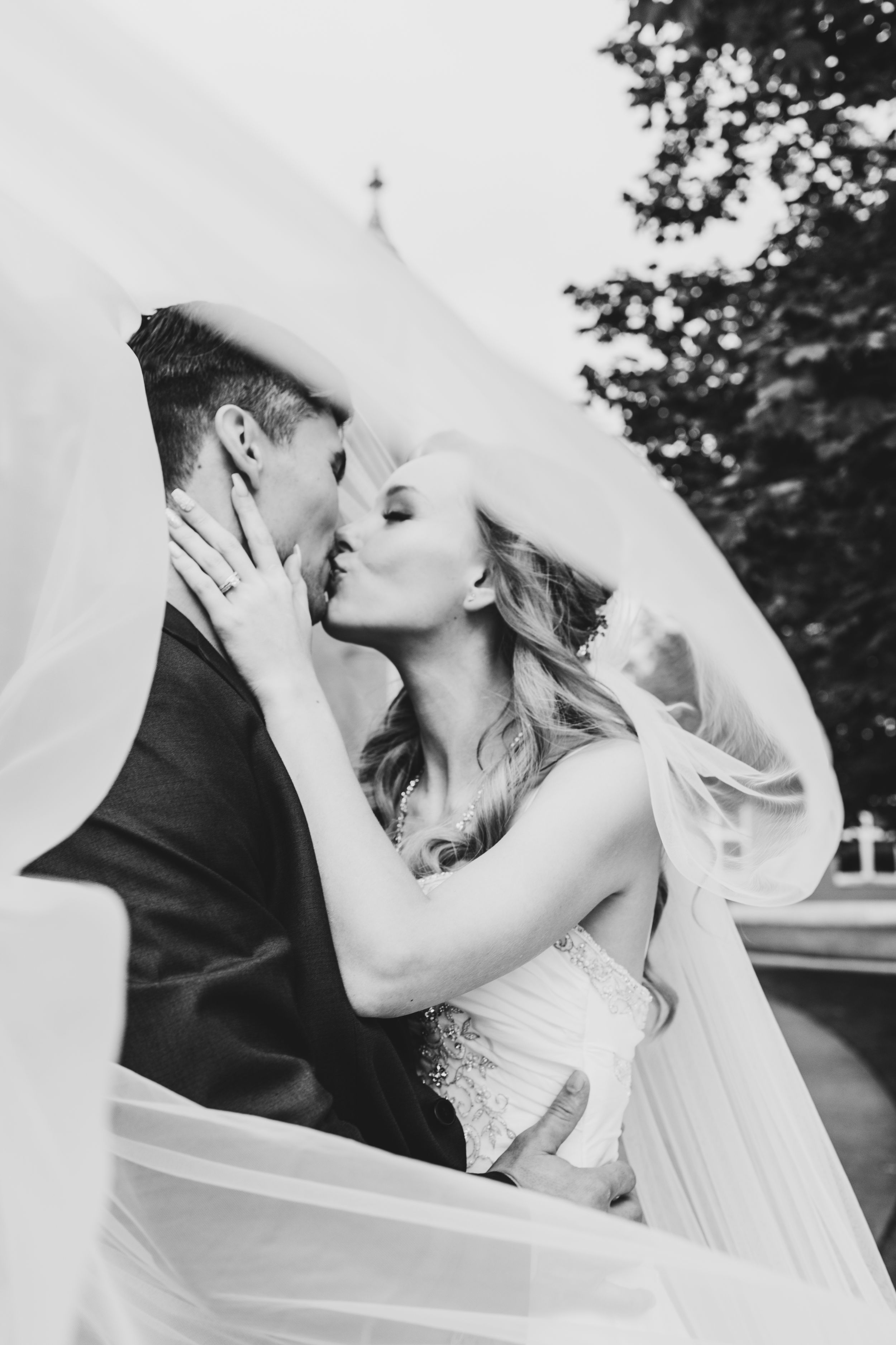 wedding couple wrapped in veil married at the London club in London Ontario