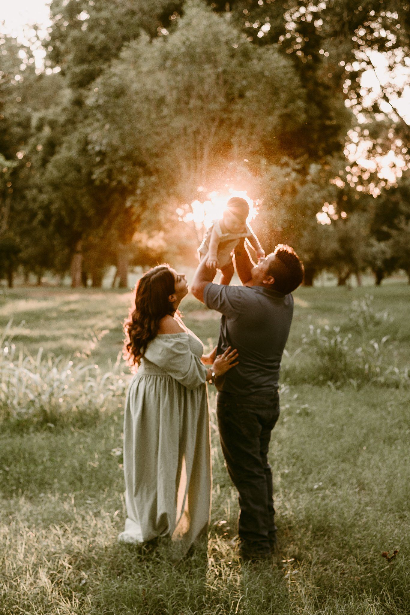 Joyful family plays together in a sun-drenched park during golden hour.