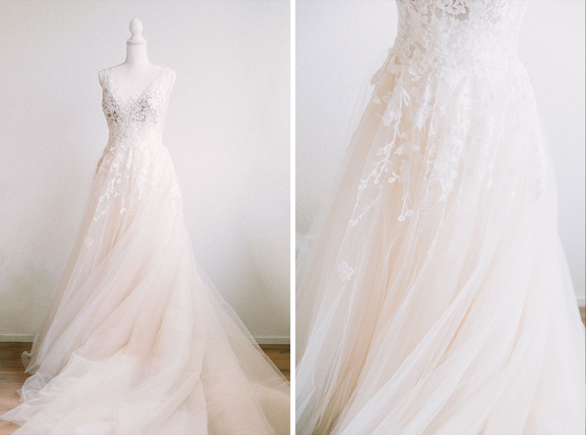 A beautiful white A-line wedding dress with a lace bodice hanging against a neutral wall.