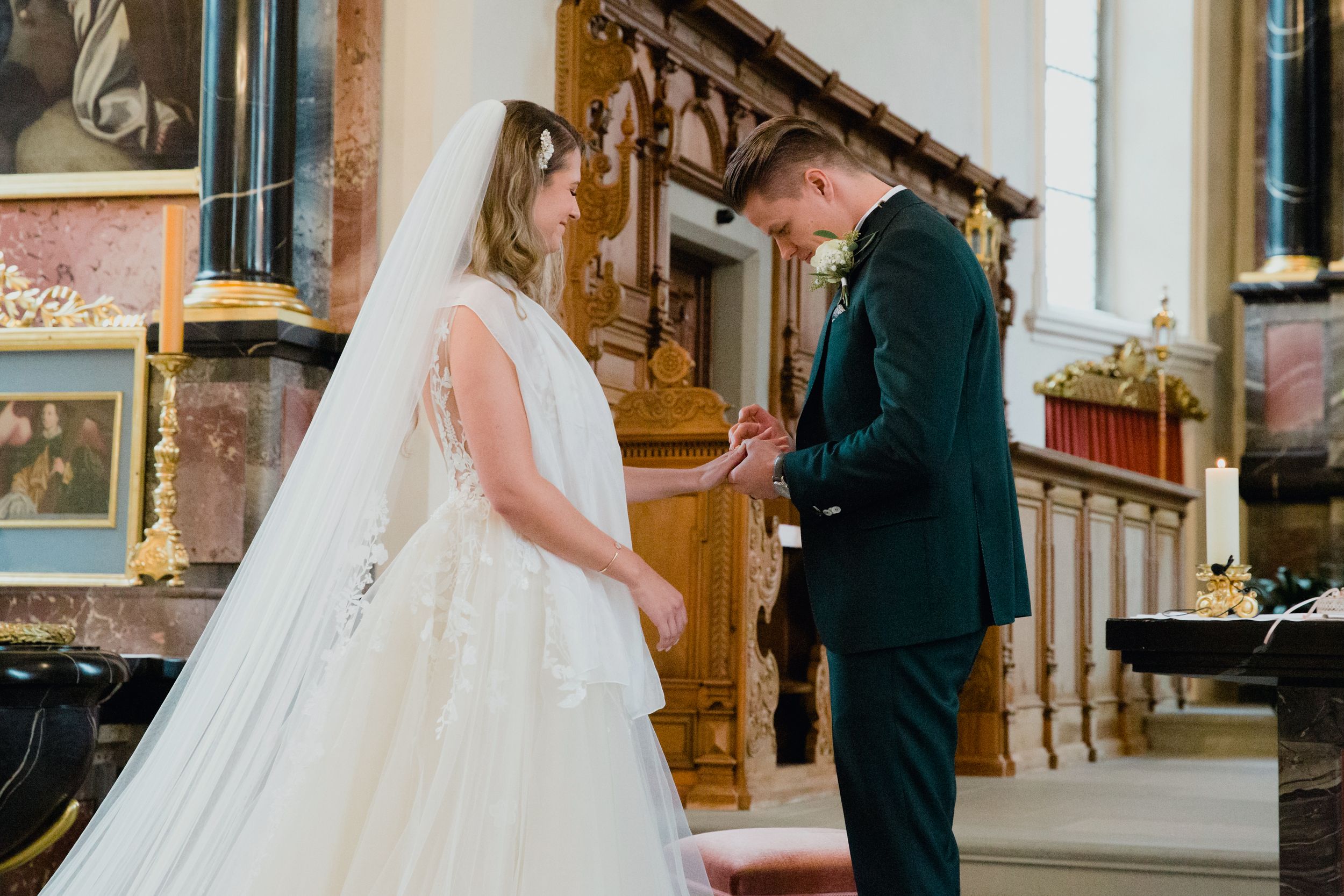 A bride and groom holding hands and looking at each other while reciting their wedding vows.