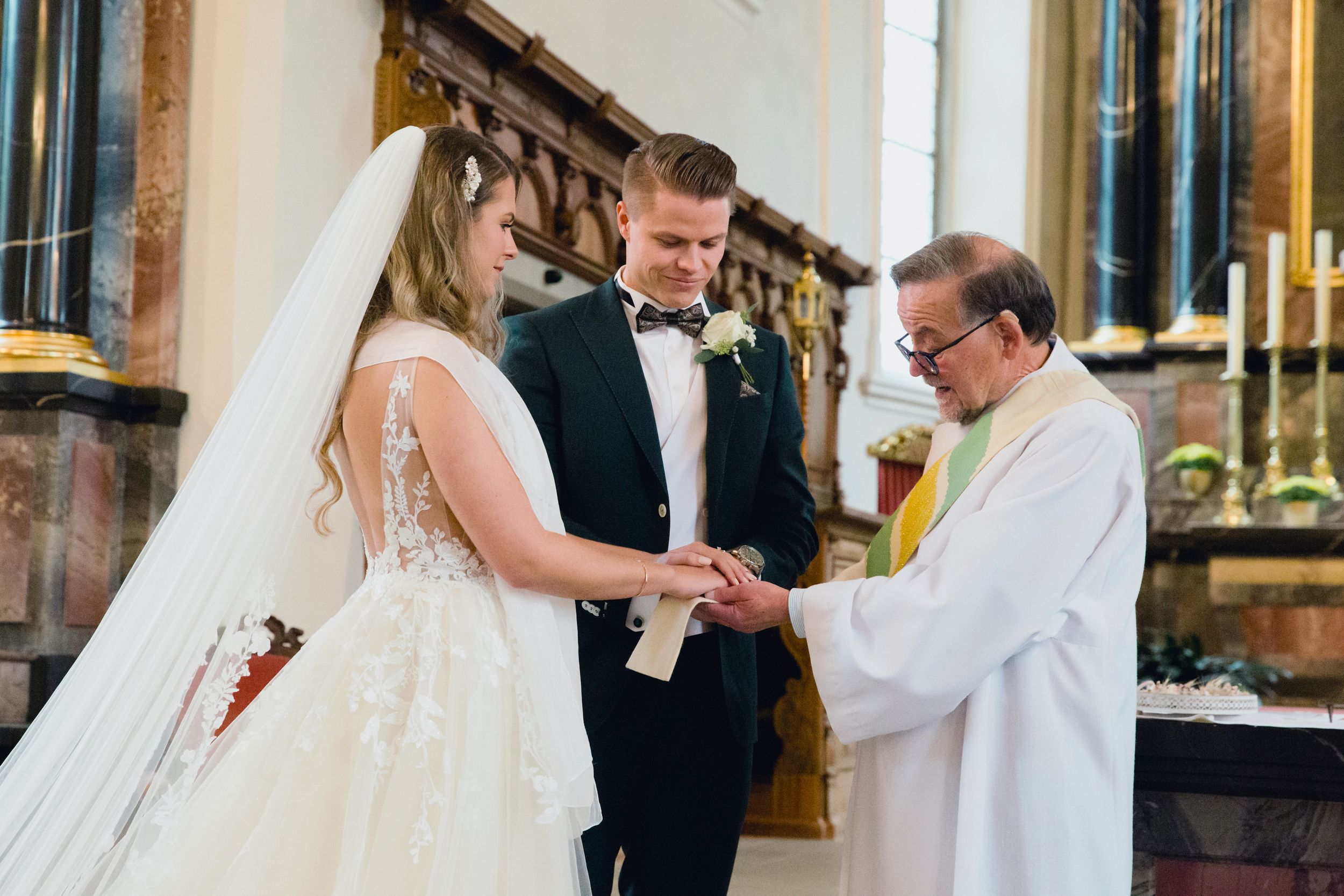 Emotional moment of a bride and groom exchanging rings during their traditional church wedding.