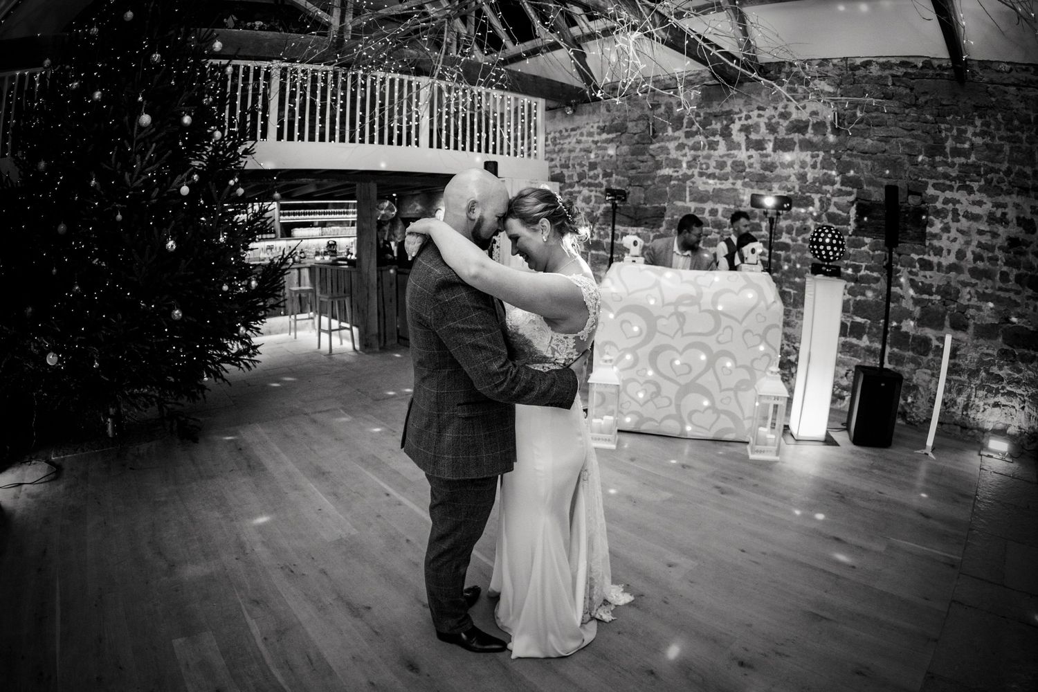 Wedding reception dance floor with guests celebrating under venue lighting.