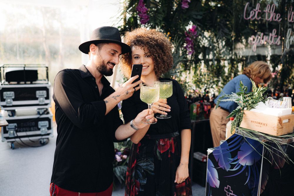 Event guests enjoying colorful cocktails at a stylish party setting.