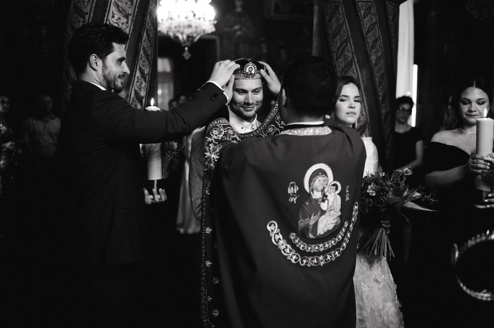 Black and white photo of an Orthodox Christian wedding ceremony showing traditional robes and candles.