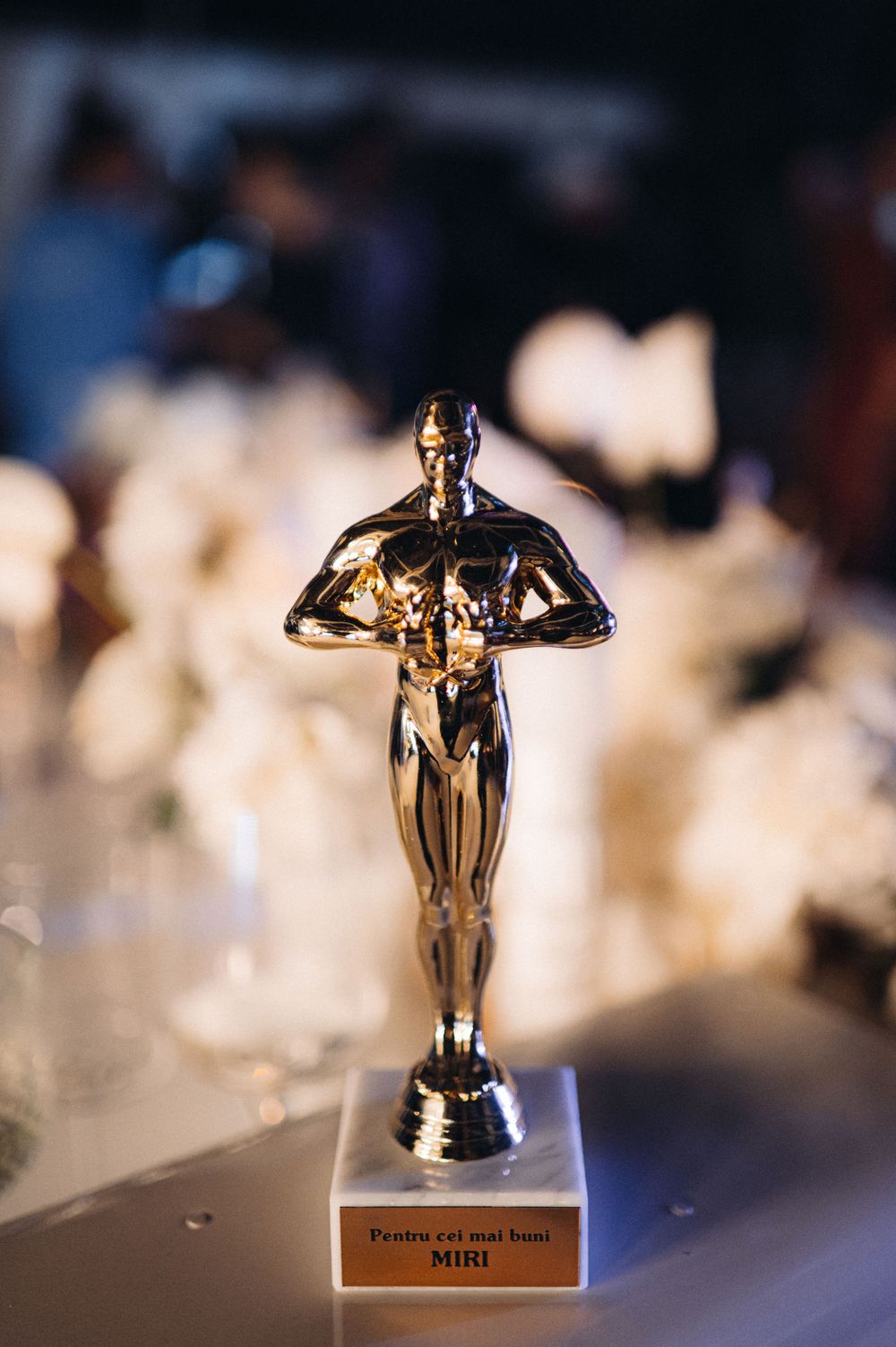 Golden Oscar-style trophy statue displayed on table at event.