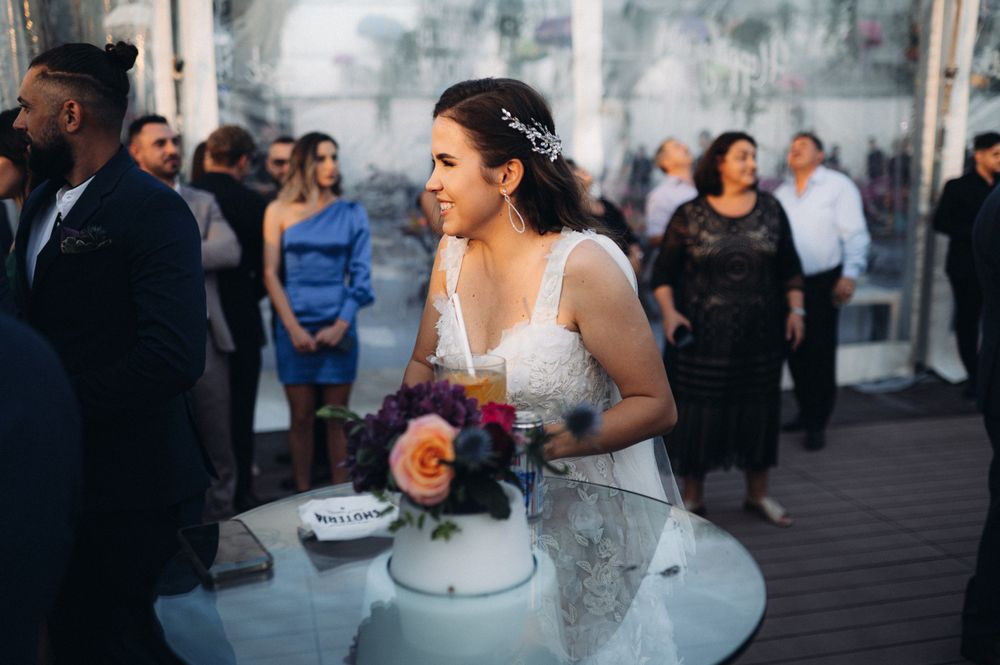 Wedding celebration with smoke effects and decorative table settings on outdoor patio.