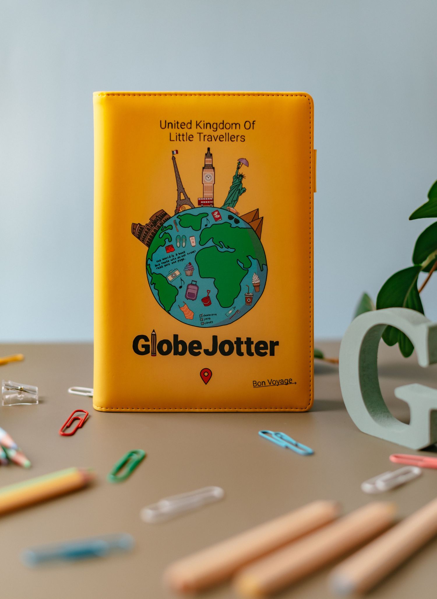 Children's Journal with props including, paper clips, coloring pencils, sharpener, artificial plant and letter 'G'