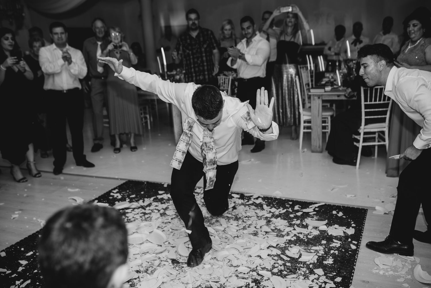 A groom on his greek wedding smashing plates at Helenekilde Badehotel in Denmark