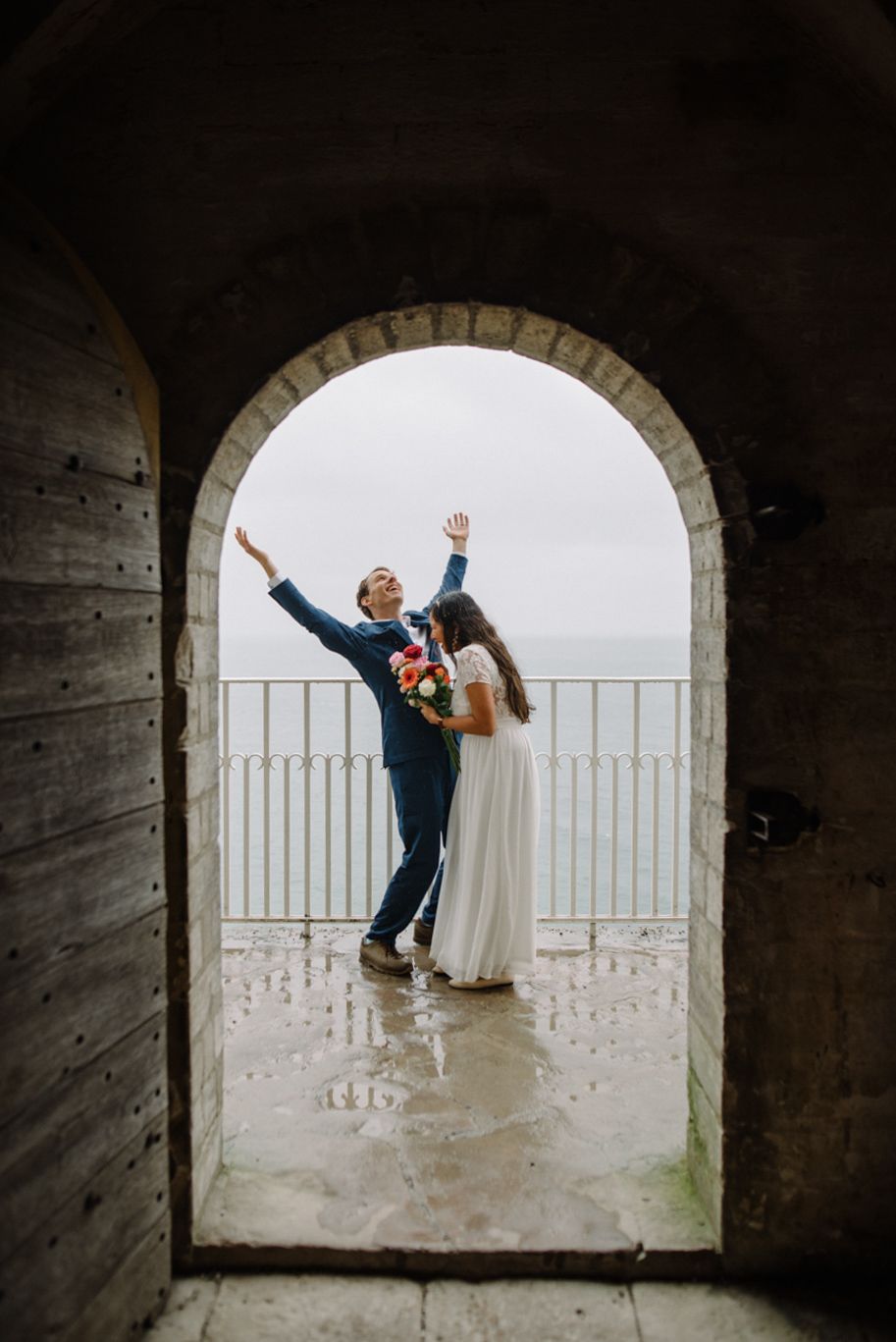 A couple on their wedding day celebrating at Højerup Old Church in Stevns Klint Denmark