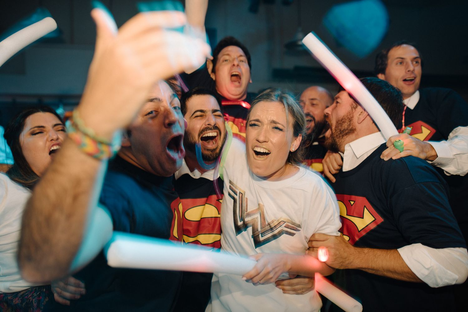 A couple on their wedding day with superman and superwoman tshirts on the dancing floor in Argentina