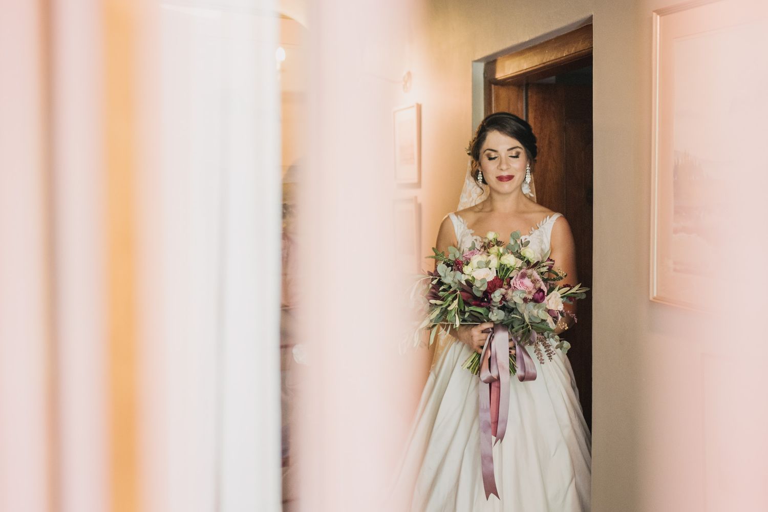 A bride with her bouquet ready to walk down the aisle at Nimb hotel in Copenhagen