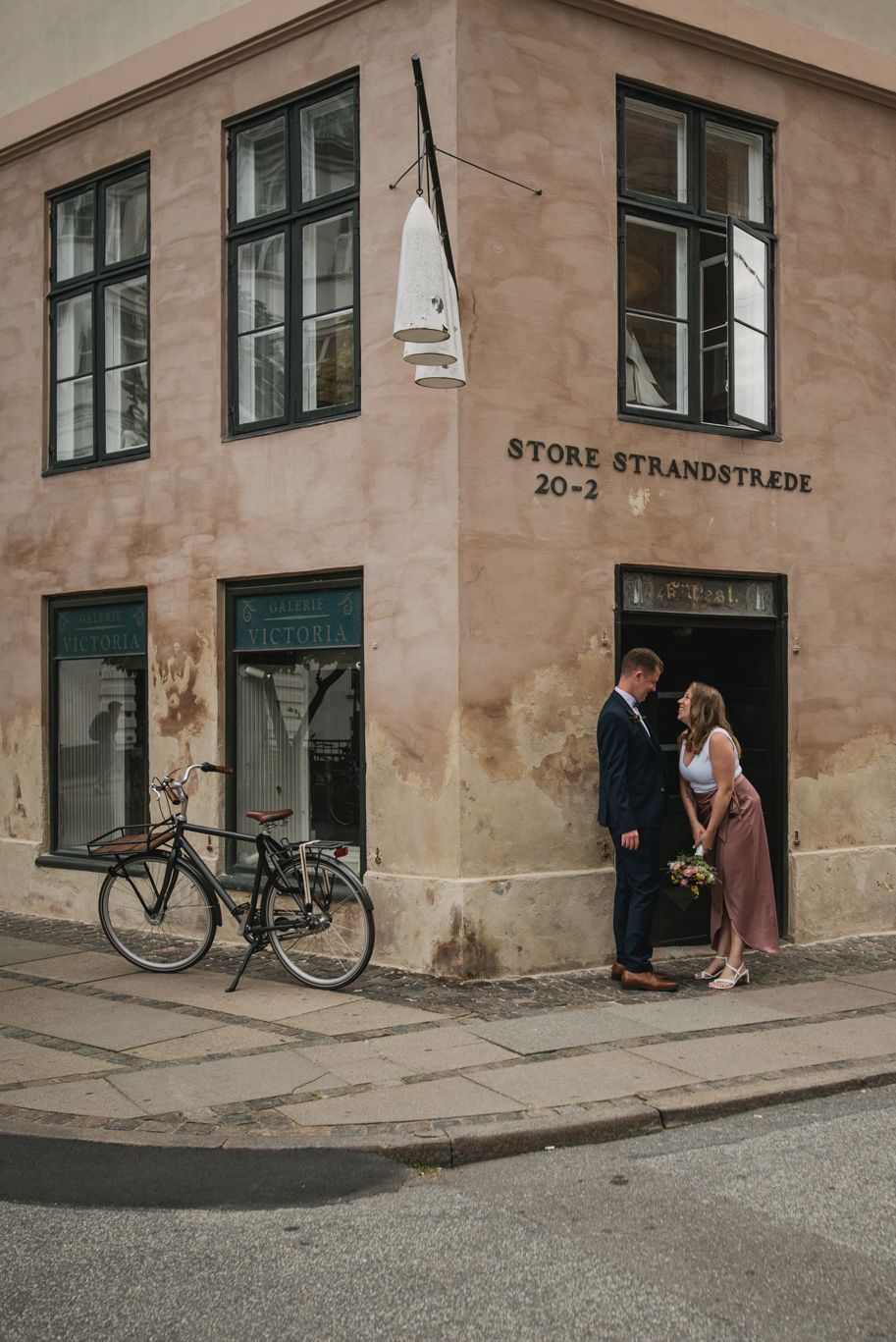 A couple on their wedding day walking around Nyhavn in Copenhagen