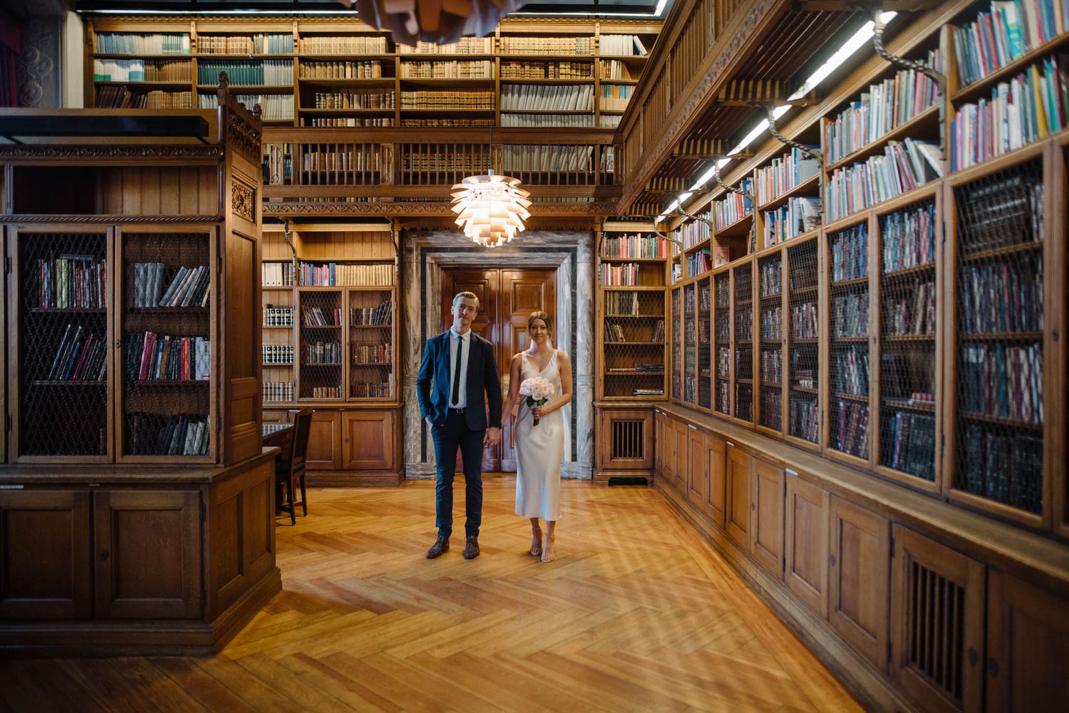 A couple on their wedding day posing at Copenhagen City Hall Library