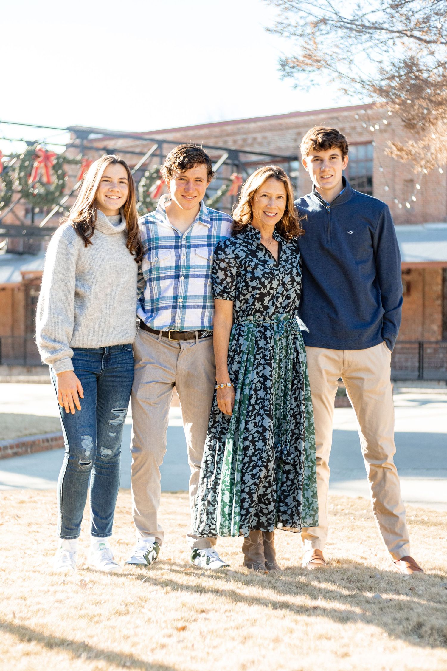 Mom and grown kids smiling in the American Tobacco Campus