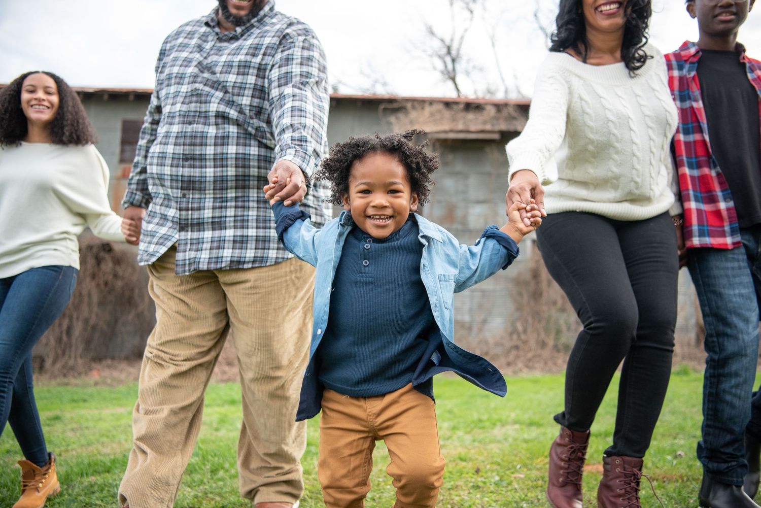 Diverse group of people walking together outdoors wearing casual clothing.