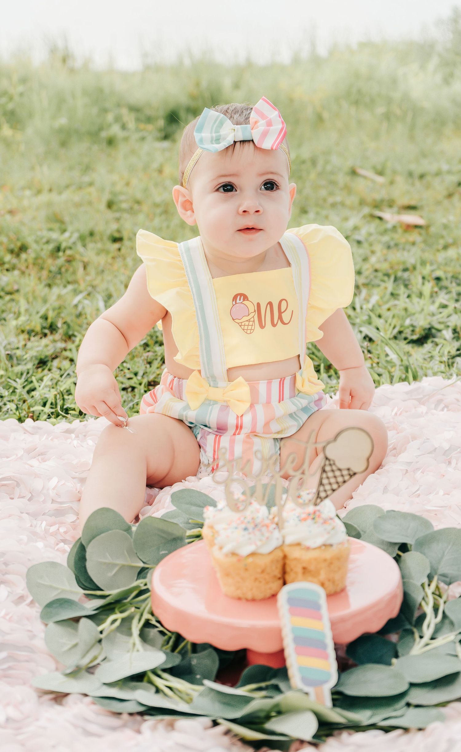 Outdoor Cake Smash Session at Maximo Park in St. Pete, FL; baby sitting with cupcakes