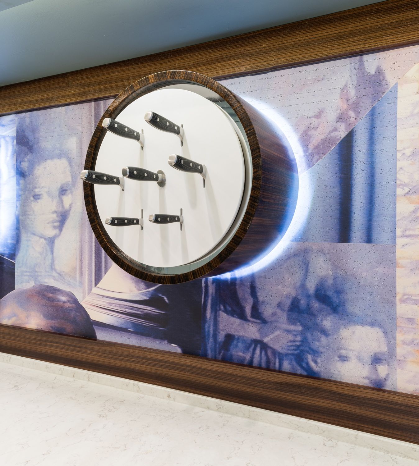 Modern kitchen installation against a blue-tinted photographic backdrop.