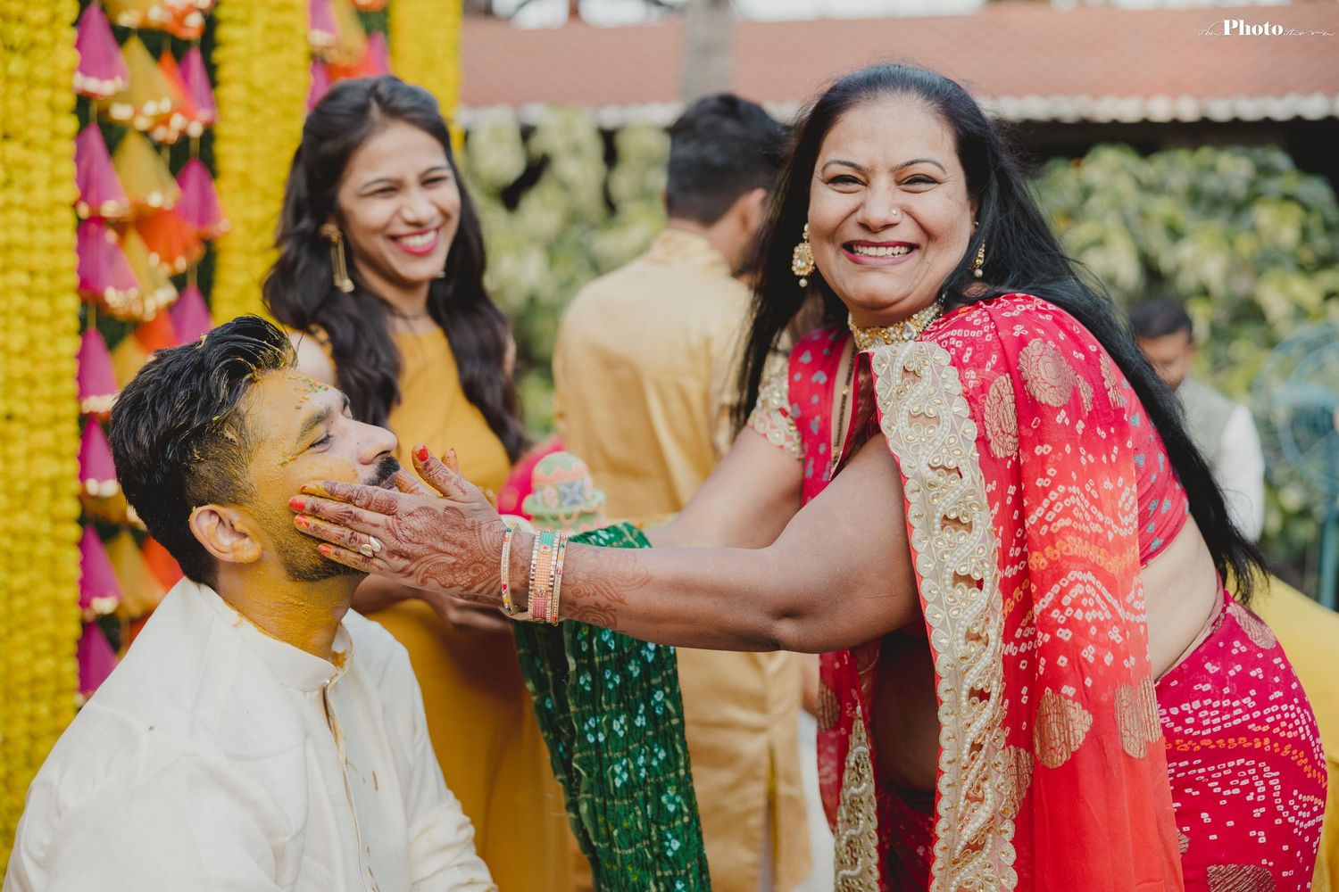 Festive moments captured during a traditional Indian pre-wedding ceremony with marigold decorations.