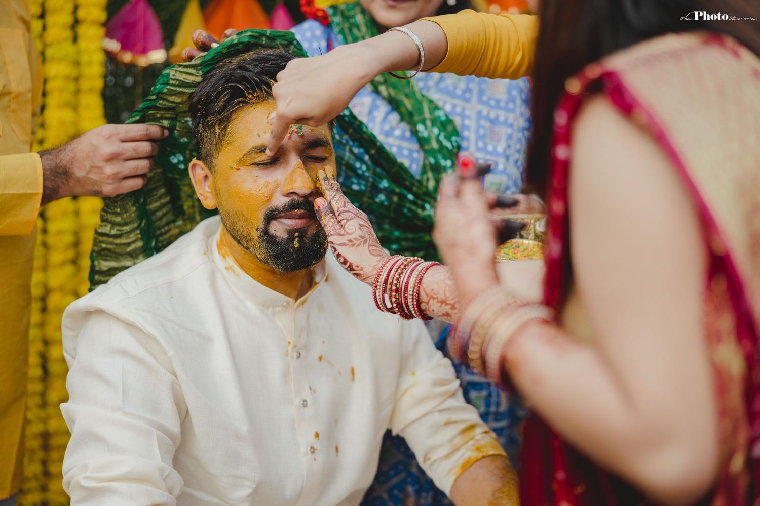 Candid moments from a Haldi ceremony showing guests participating in traditional rituals.