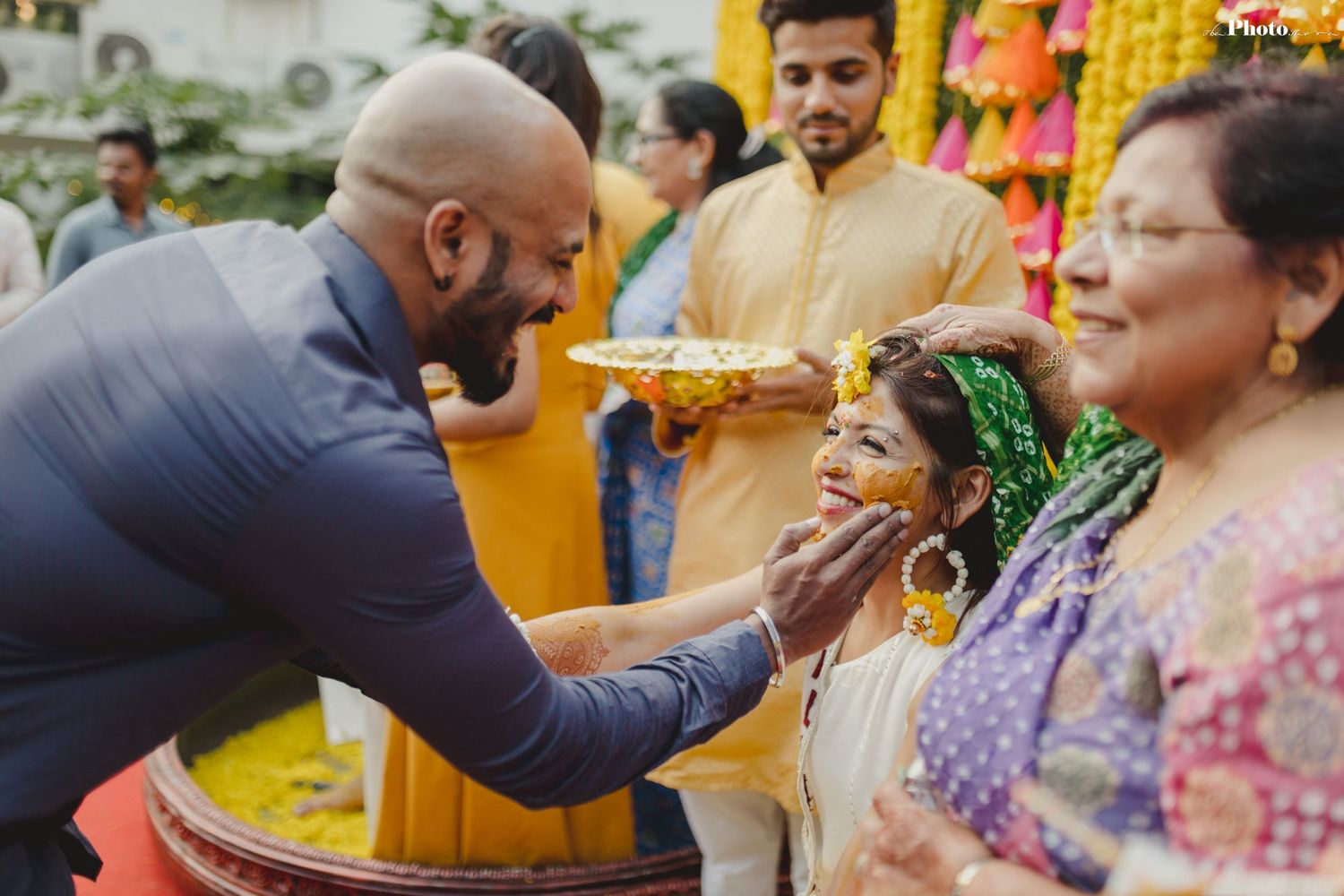 Celebratory moments during an Indian wedding ceremony with traditional customs and decorations.