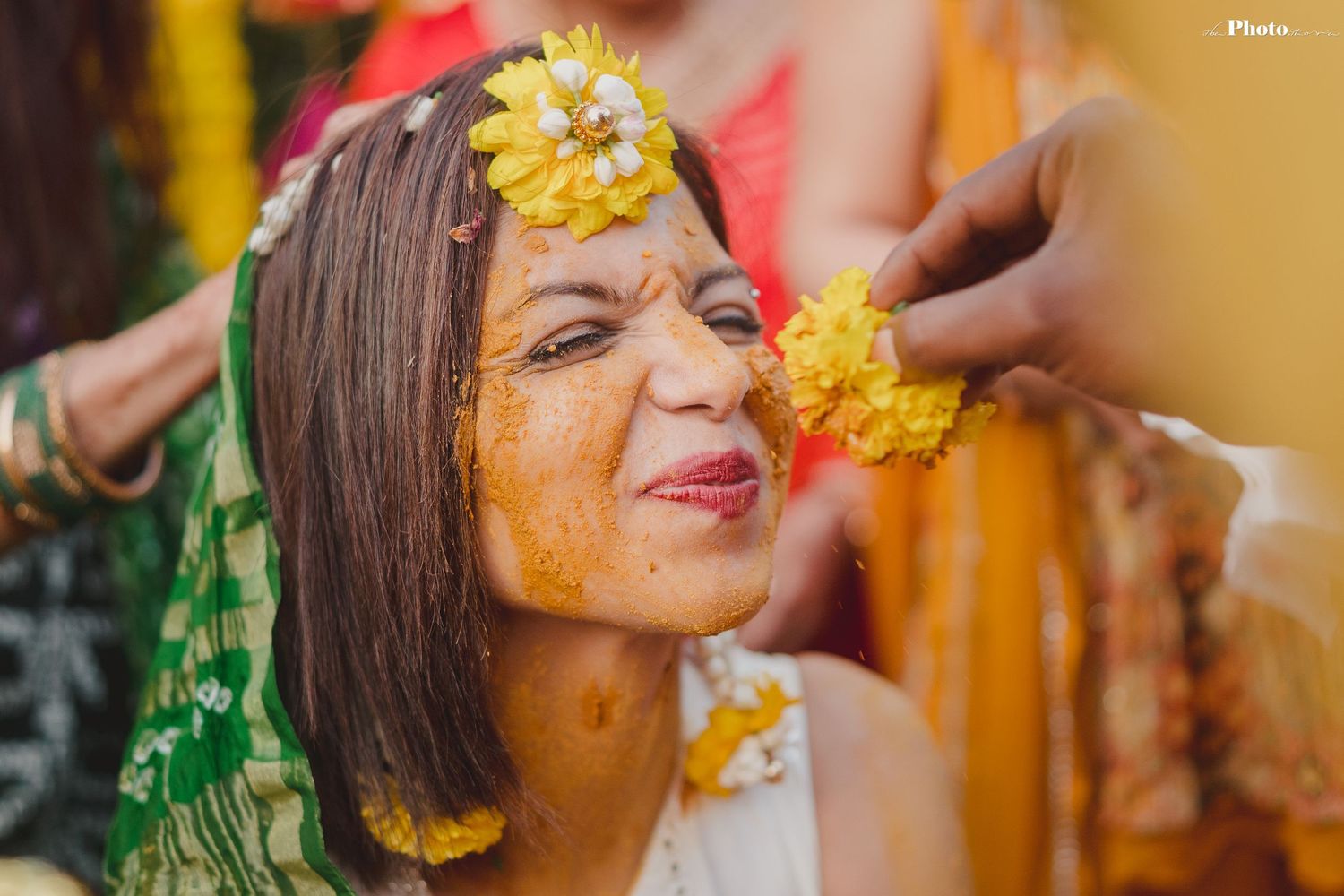 Close-up shots of joyful moments during a Haldi ceremony with yellow turmeric applications.