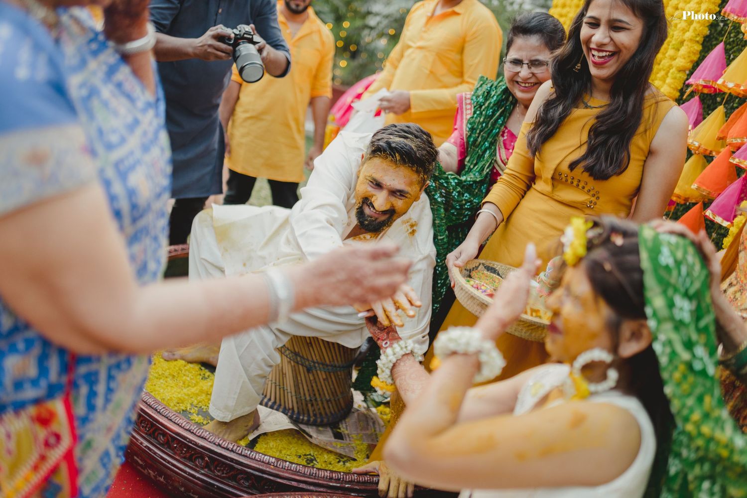 Candid moments of celebration during a traditional Indian pre-wedding Haldi ceremony.