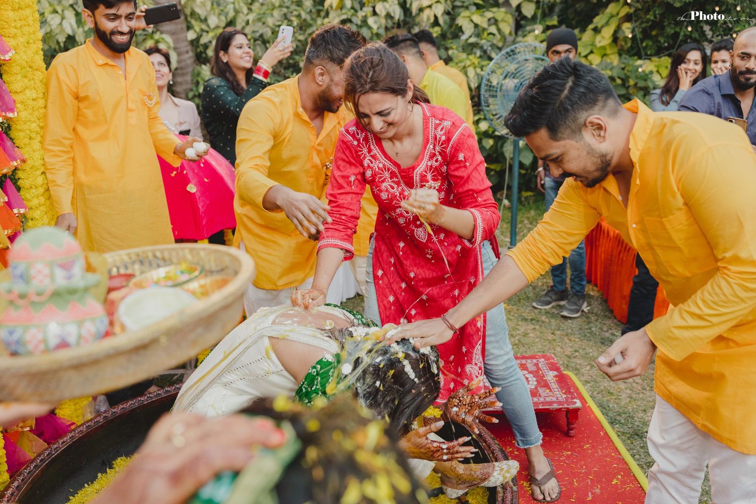 Joyful moments captured during a traditional Haldi ceremony with vibrant decorations.