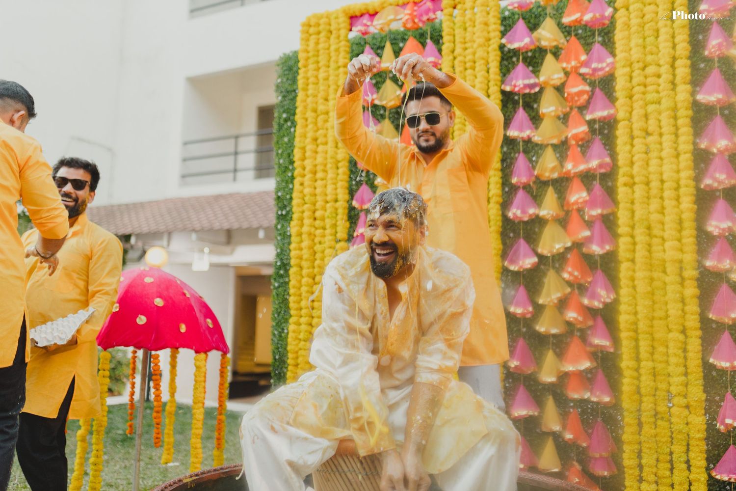 Festive celebration with yellow marigold garlands and colorful decorations adorning an outdoor venue.