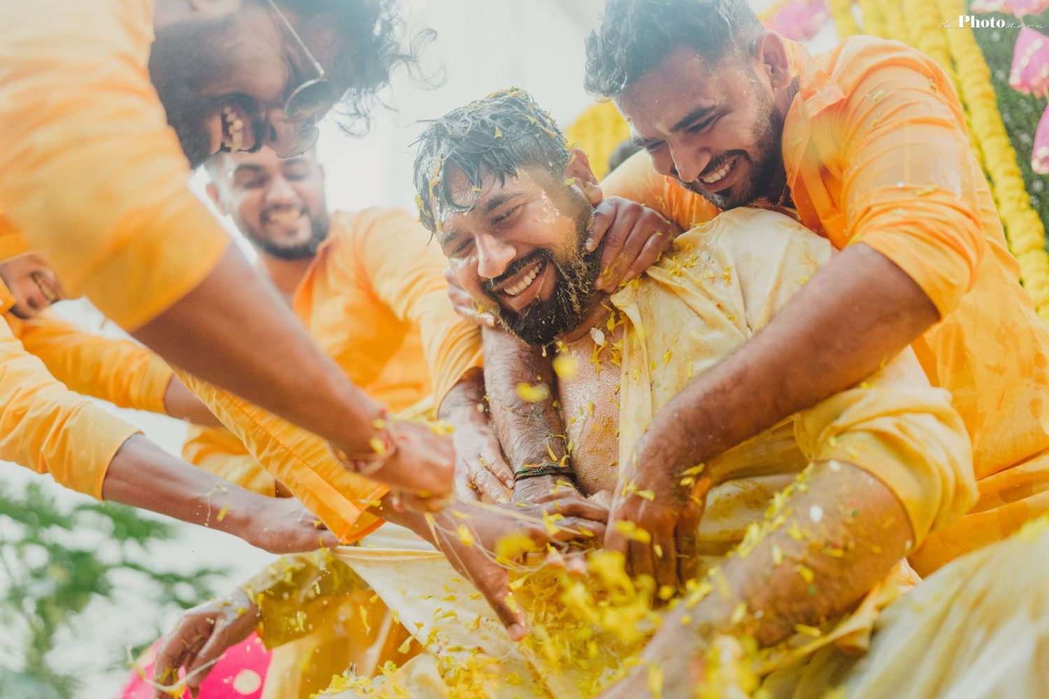 Energetic celebration with yellow-clad participants during traditional ceremony.