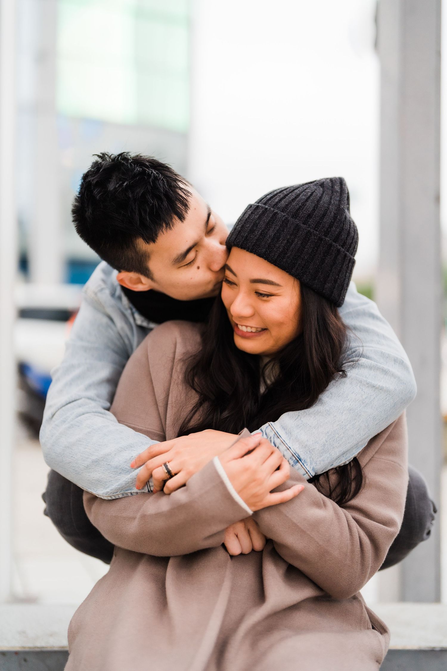 Couple sharing intimate moment while wearing winter clothes.