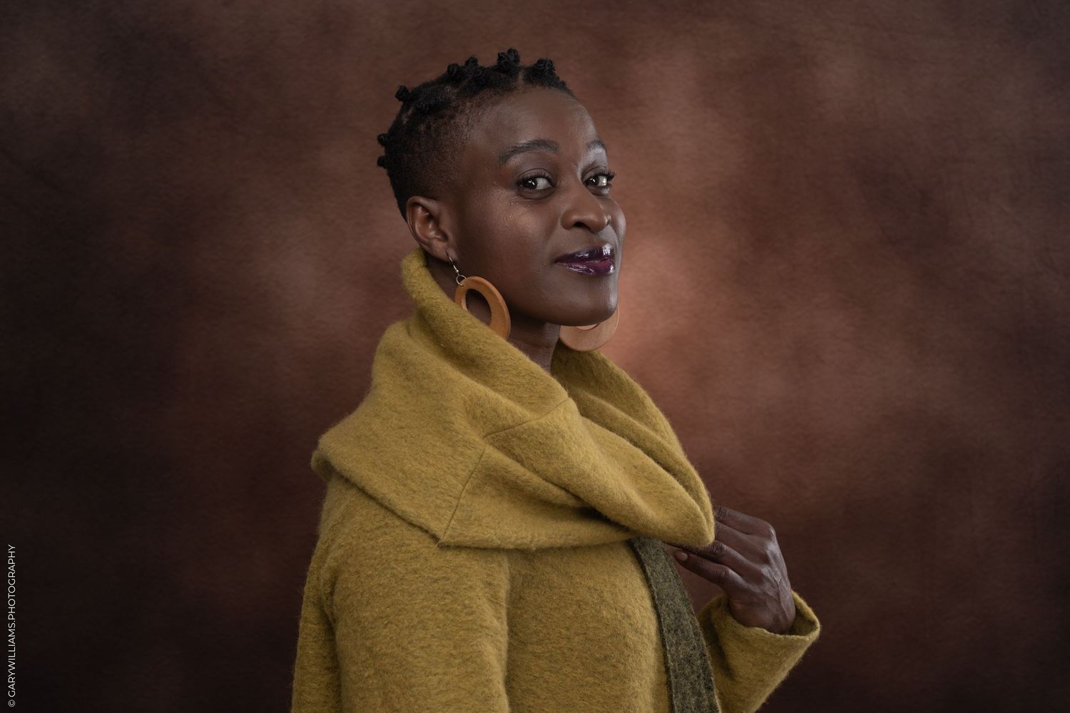 A black woman poses for headshots in London.