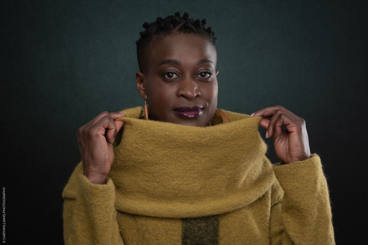 A black woman poses for headshots in London.