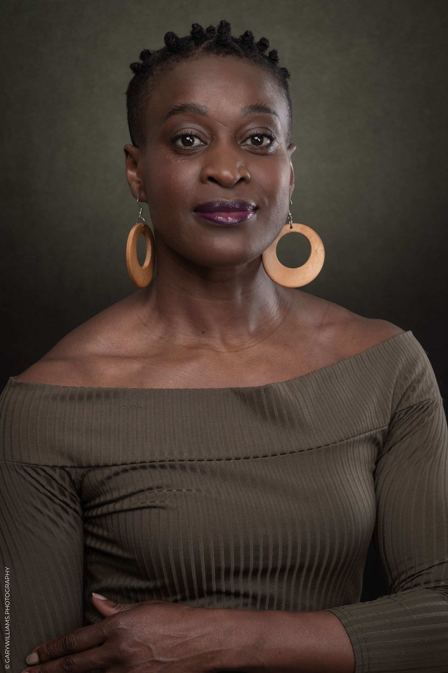 A black woman poses for headshots in London.