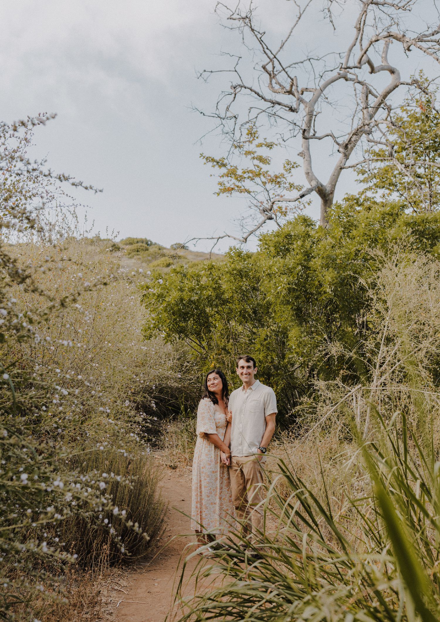 E. Noelle Photography couple engagement in the Los Angeles Malibu hills casual pose in front of tree looking off