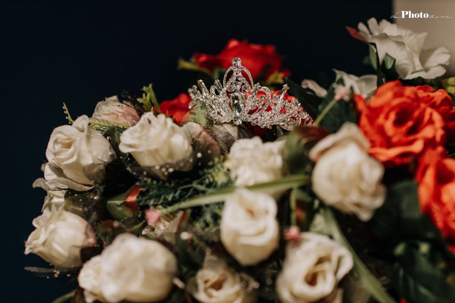 Elegant arrangement of white and coral roses with delicate greenery.